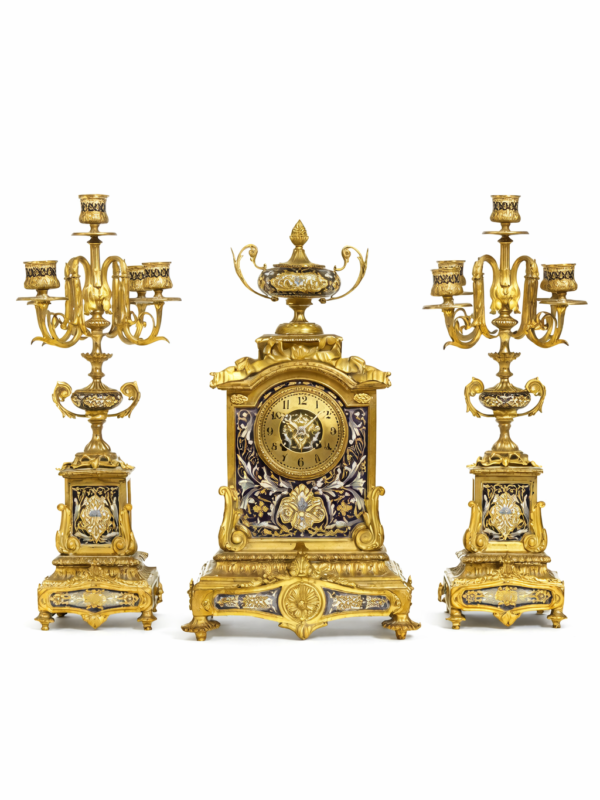 A French gilt bronze and champlevé enamel clock garniture