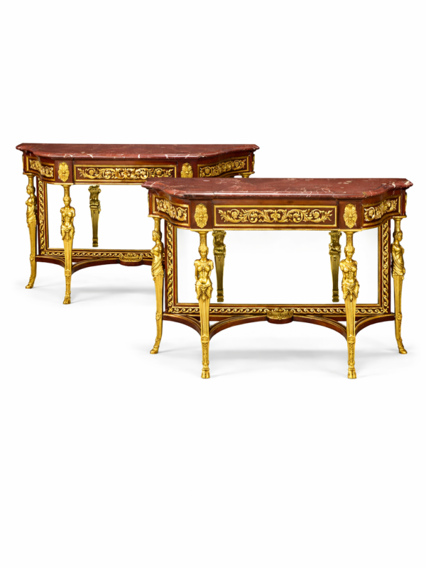 A pair of Louis XVI style gilt bronze mounted mahogany consoles
