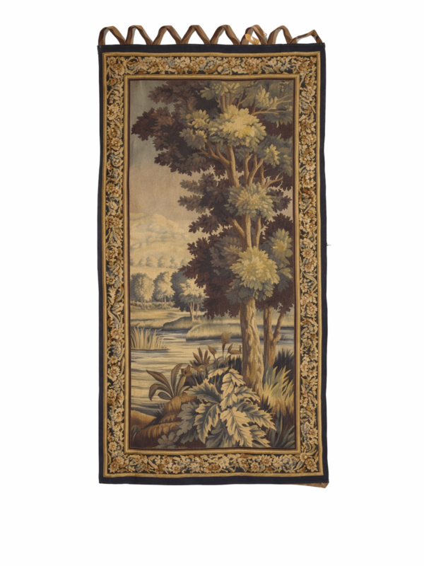 Aubusson verdure tapestry,circa 1850 unsigned.depicting a forest interior enclosed in a foliate border